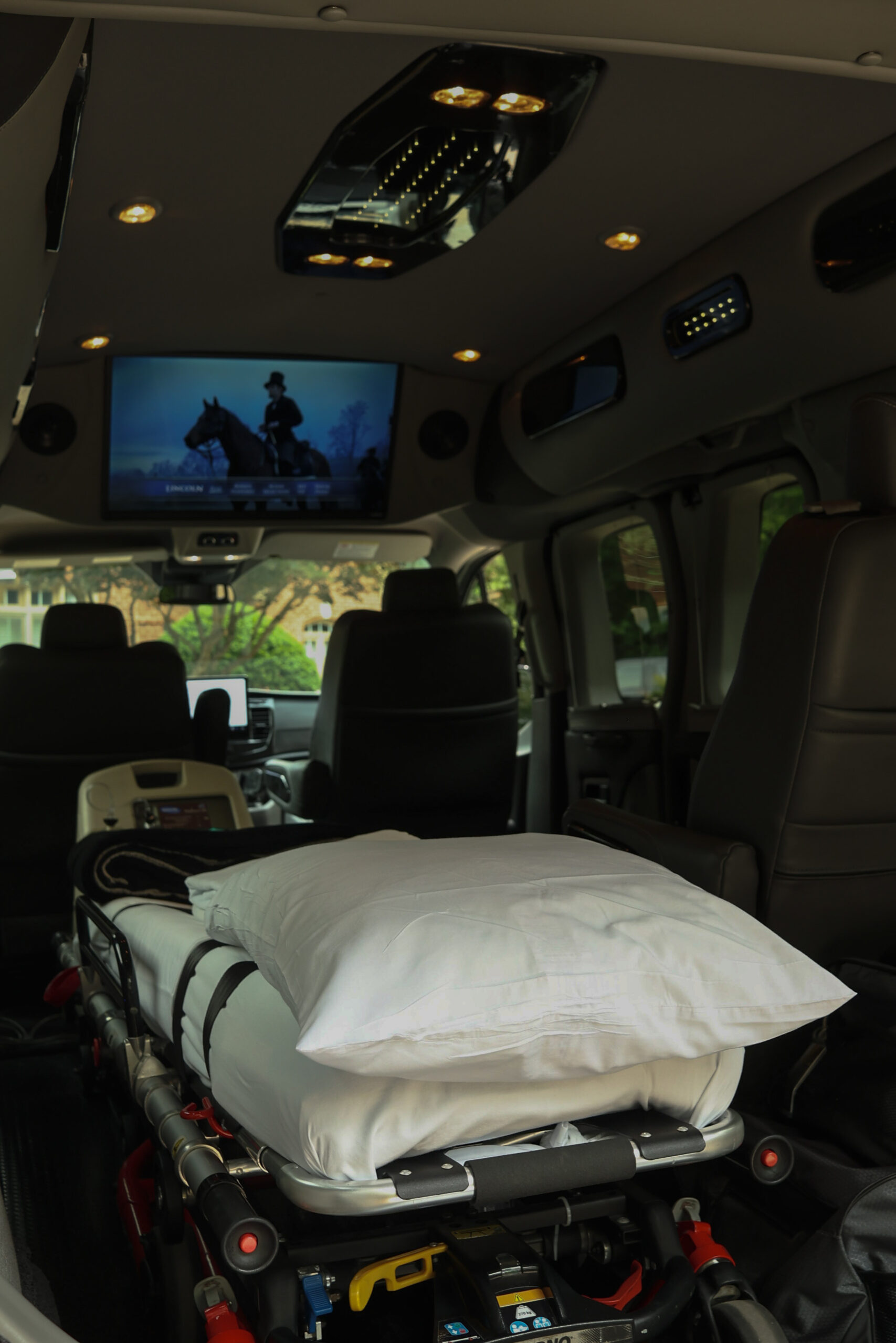 Van with car seat and head restraint for safe medical transport.
